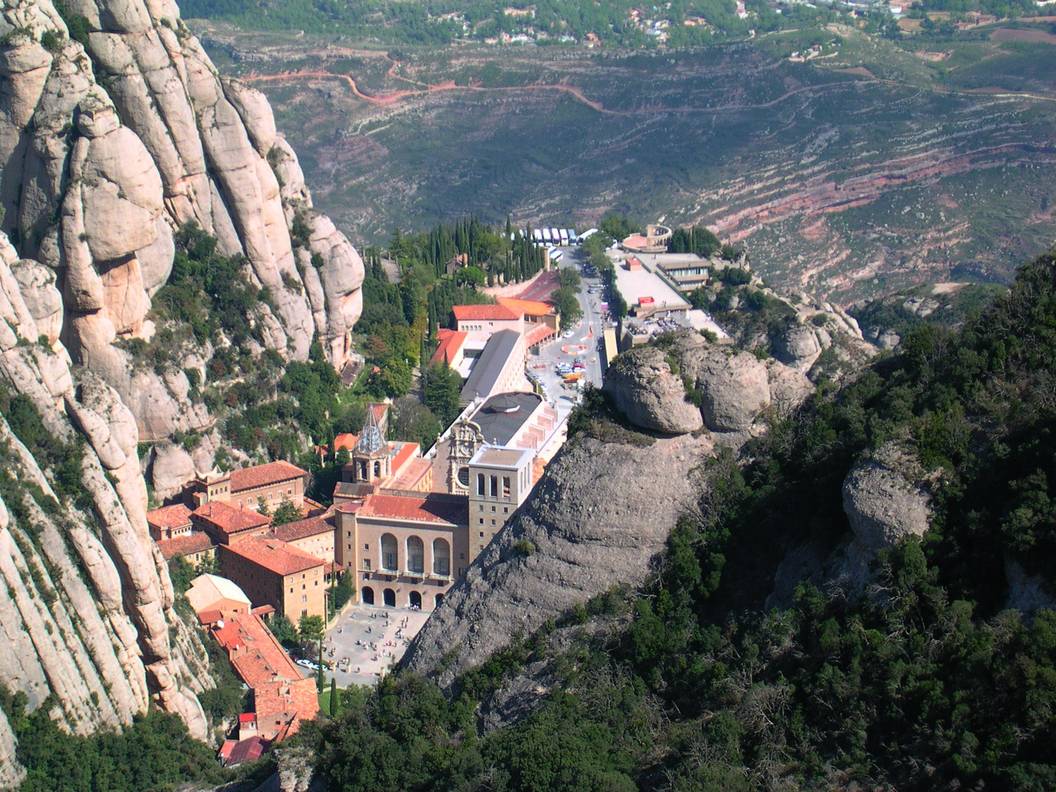 View from the top: the Abbey at Santa Maria de Montserrat. Yes, we’ll be cycling up to the abbey. From way down there in the valley. And did we mention it’s gravel? (Creative Commons license)