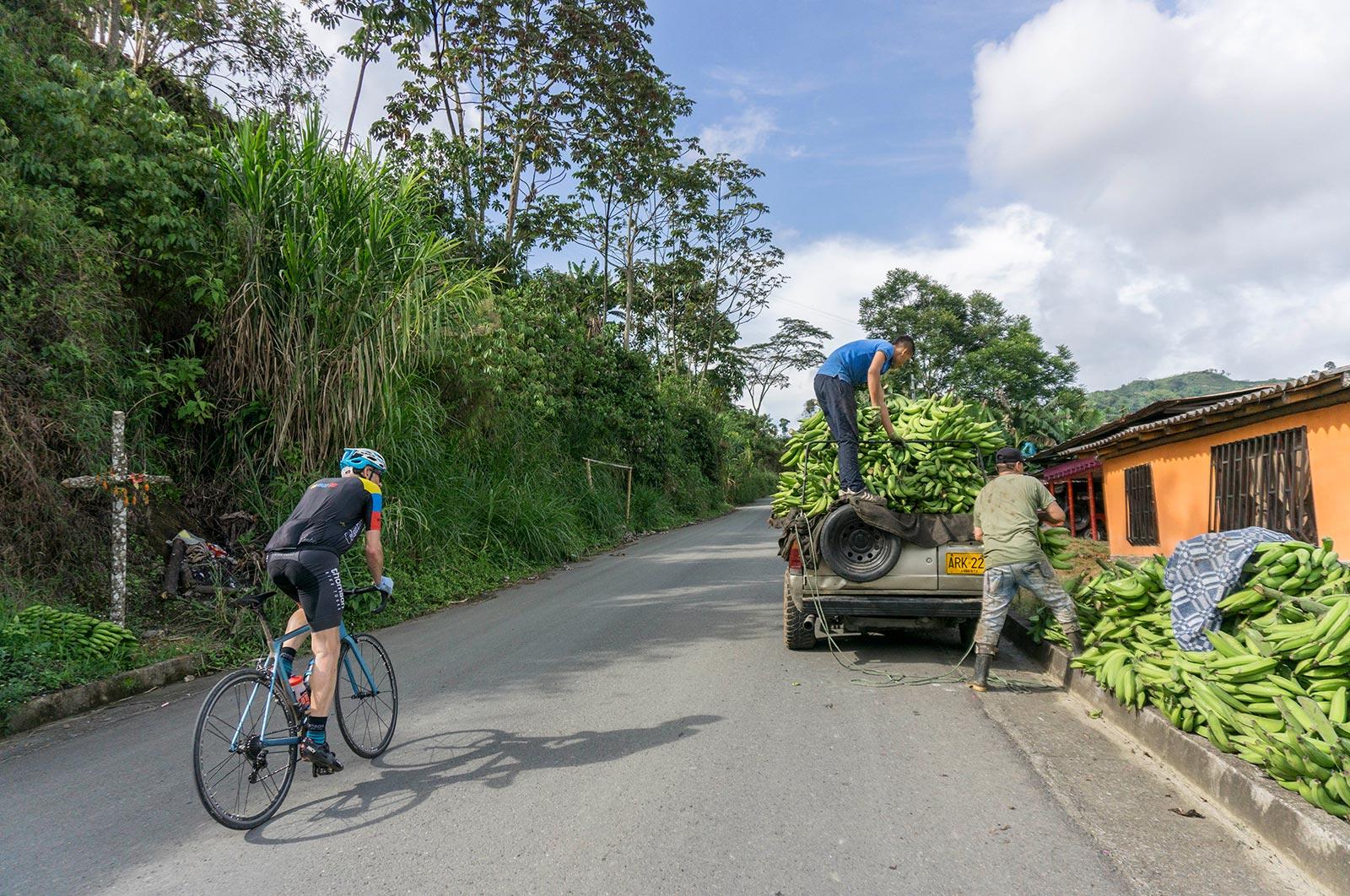 Thomson bike tours in Colombia, cycling past some banana farmers