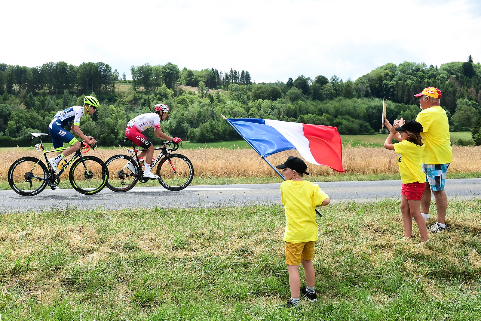 A young fan waves a French tricolour at the Tour de France